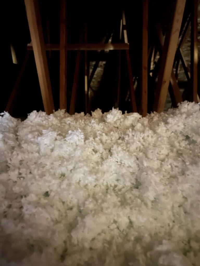 Close-up of the depth of new blown attic insulation