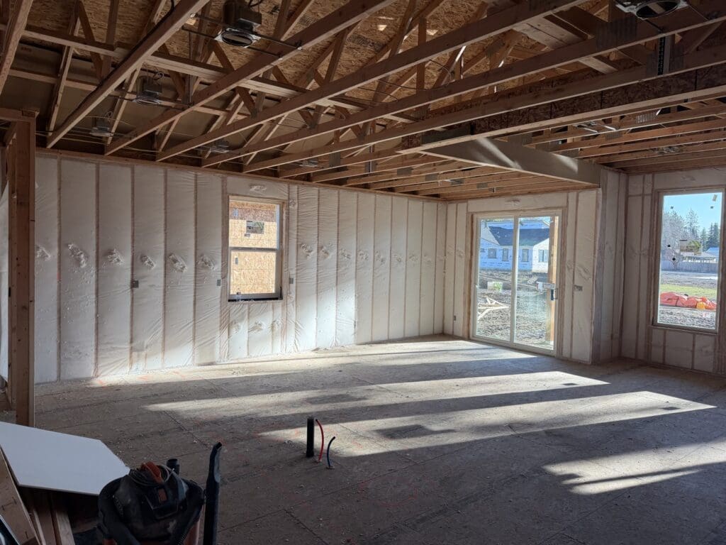 New-build walls insulated with Fiberglass BIBS, blown fiberglass behind netting