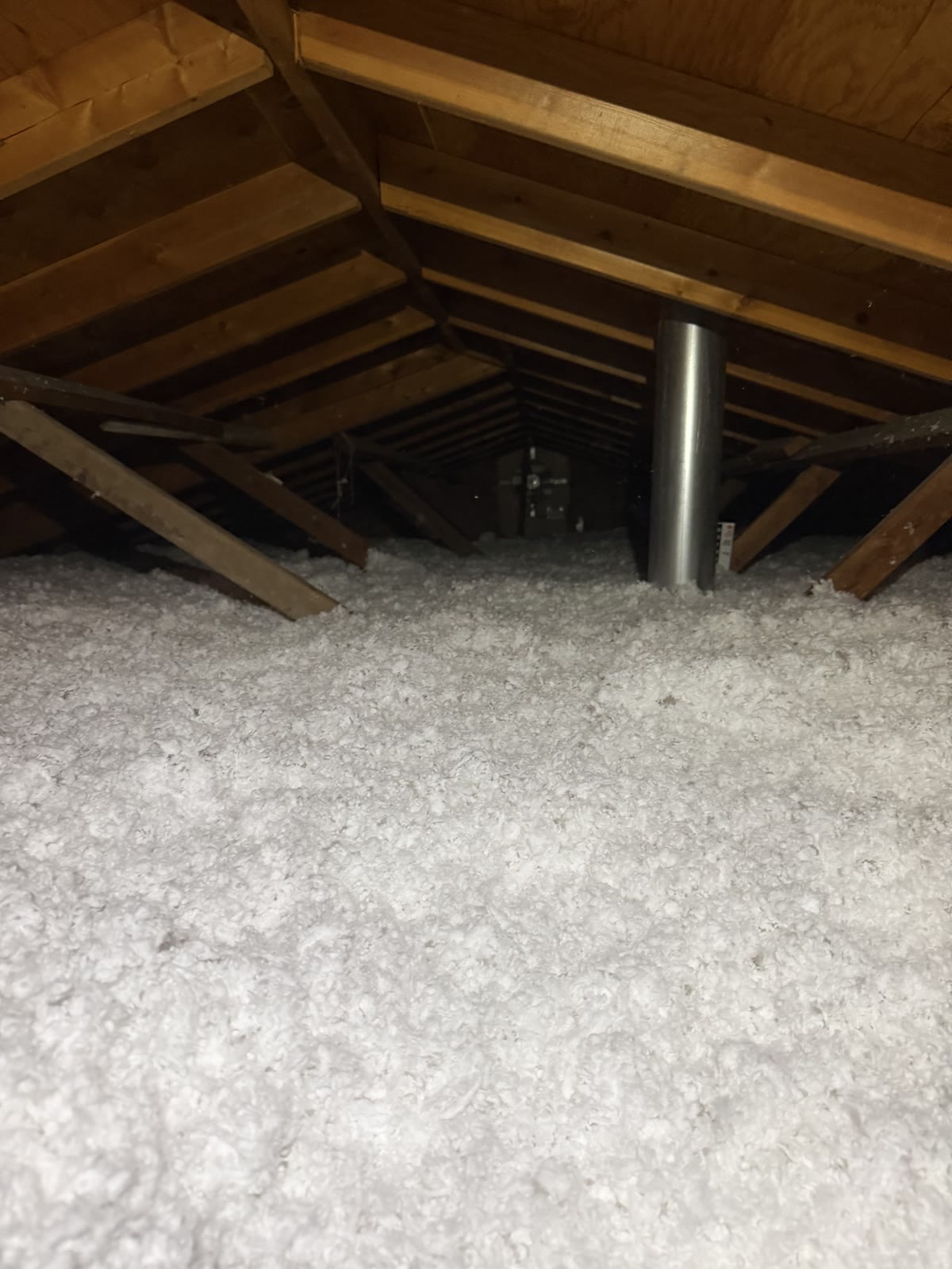Attic after: deep, fresh white blown fiberglass insulation covering the attic floor